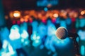 microphone on a stand up comedy stage with colorful bokeh , high contrast image. Royalty Free Stock Photo