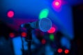 Microphone stands on stage in a nightclub. Bright club light shines on MIC. Performances in the night club Royalty Free Stock Photo