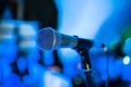 Microphone stands on stage in a nightclub. Bright club light shines on MIC. Performances in the night club Royalty Free Stock Photo