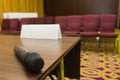 Microphone on table at press conference hall or seminar room background Royalty Free Stock Photo