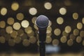 Microphone on Theater Stage Amidst Softly Blurred Lights Before the Concert