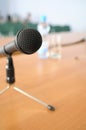 Microphone on tripod stand on a table.