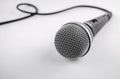 Microphone with a wire on white background. Silver mic Royalty Free Stock Photo