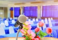 Microphone wireless on stand and flower in meeting room seminar empty conference background