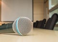 Microphone on wood desk in meeting room under window light