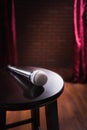 Microphone on a wood stool on a stage