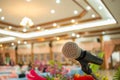 Microphones on abstract blurred of speech in seminar room or front speaking conference hall light, white chairs for people in Royalty Free Stock Photo