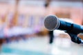 Microphones on abstract blurred of speech in seminar room, speaking conference hall light for presentation in exhibition event Royalty Free Stock Photo