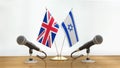 Microphones and flags pair on a desk over defocused background Royalty Free Stock Photo