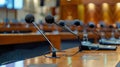 Microphones standing on a conference table in a meeting room Royalty Free Stock Photo