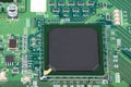 A microprocessor soldered into a green motherboard