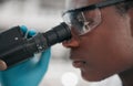 Microscope, black man and healthcare with research, medical and dna test with biotechnology. African person, science and