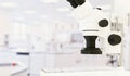 Microscope for chemical, biological, general medical tests in medical laboratory on unfocused background and copy space