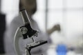 Microscope detection of chemical cosmetics, Background female chemist blurred,Concept for developing Safe Cosmetics Formula for Co Royalty Free Stock Photo