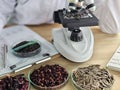 Microscope and dried herbs used for scientific study in a lab setting Royalty Free Stock Photo