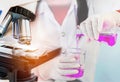 Microscope equipment for research experiments with scientist woman carrying research chemistry liquid to test tube Royalty Free Stock Photo