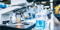 Microscope and flask with blue liquid on a lab bench, illuminating a sample for scientific analysis and research development Royalty Free Stock Photo