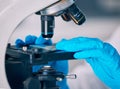 Microscope, hands and science worker research with technology testing for a pharmaceutical or medical study. Chemistry