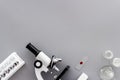 Microscope medical reserch. Blood sample for analysis. Grey table top view copy space