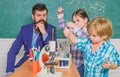 Microscope optical instrument at science classroom. back to school. happy children teacher. learn using microscope at