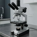 A microscope with a robust metal frame and dual eyepiece tubes. The objective Royalty Free Stock Photo