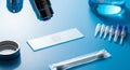 Microscope, Slides, and Laboratory Equipment on Blue Surface Royalty Free Stock Photo