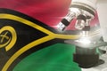 Microscope on Vanuatu flag background - science development concept. Research in chemistry or cell life 3D illustration of object