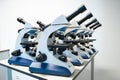 Microscopes lined up in a school lab ready for biology lessons. Royalty Free Stock Photo