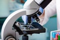 Microscopist scientist examining biological samples with a microscope in the laboratory