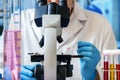 Microscopist working with biological samples in the microscope of the microbiology laboratory