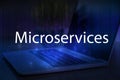 Microservices text on blue technology background with laptop