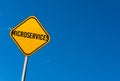 Microservices - yellow sign with blue sky