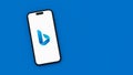 Microsoft Bing Logo on Mobile Phone Screen on Blue Background with Copy Space Royalty Free Stock Photo
