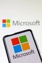 Microsoft logo of the software company on a mobile phone and computer screen