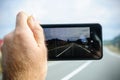 Microsoft lumia phone in hand taking photo of highway