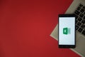 Microsoft office excel logo on smartphone screen placed on laptop keyboard. Royalty Free Stock Photo