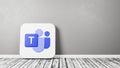 Microsoft Teams Logo on Wooden Floor Against Wall Royalty Free Stock Photo