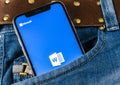 Microsoft word application icon on Apple iPhone X screen close-up in jeans pocket. Microsoft office word icon. Microsoft office on