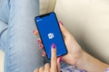 Microsoft Word application icon on Apple iPhone X screen close-up in woman hands. Microsoft office word icon. Microsoft office on