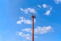 Microwave and cellular tower with partly cloudy blue sky Royalty Free Stock Photo