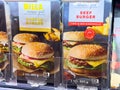 Microwave cheeseburger and beef burger packaging in grocery display Royalty Free Stock Photo