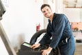 Smiling Expert Balancing Car Wheel In Garage Royalty Free Stock Photo