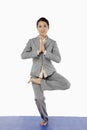 Mid adult businesswoman doing yoga. Conceptual image Royalty Free Stock Photo