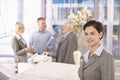 Mid-adult businesswoman in office with colleagues