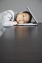 Mid adult businesswoman sleeping on laptop. Conceptual image Royalty Free Stock Photo