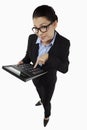 Mid adult businesswoman using big calculator. Conceptual image