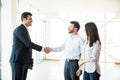 Estate Agent Congratulating To Couple For Buying New House Royalty Free Stock Photo