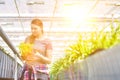 Mid adult female botanist examining herb seedlings in plant nursery Royalty Free Stock Photo