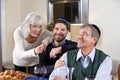 Mid-adult Jewish man at home with senior parents