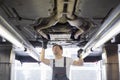 Mid adult male repair worker repairing car in workshop